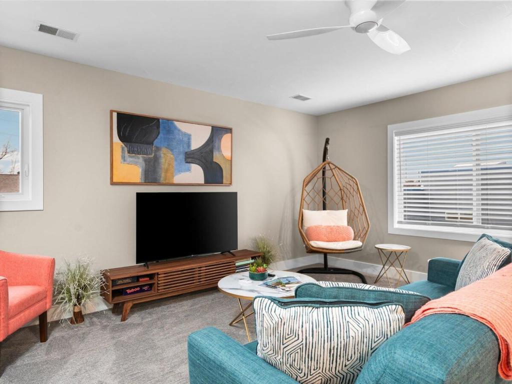 a living room with a couch and a flat screen tv at TC Parkside G: Spacious 2BR Condo in Traverse City