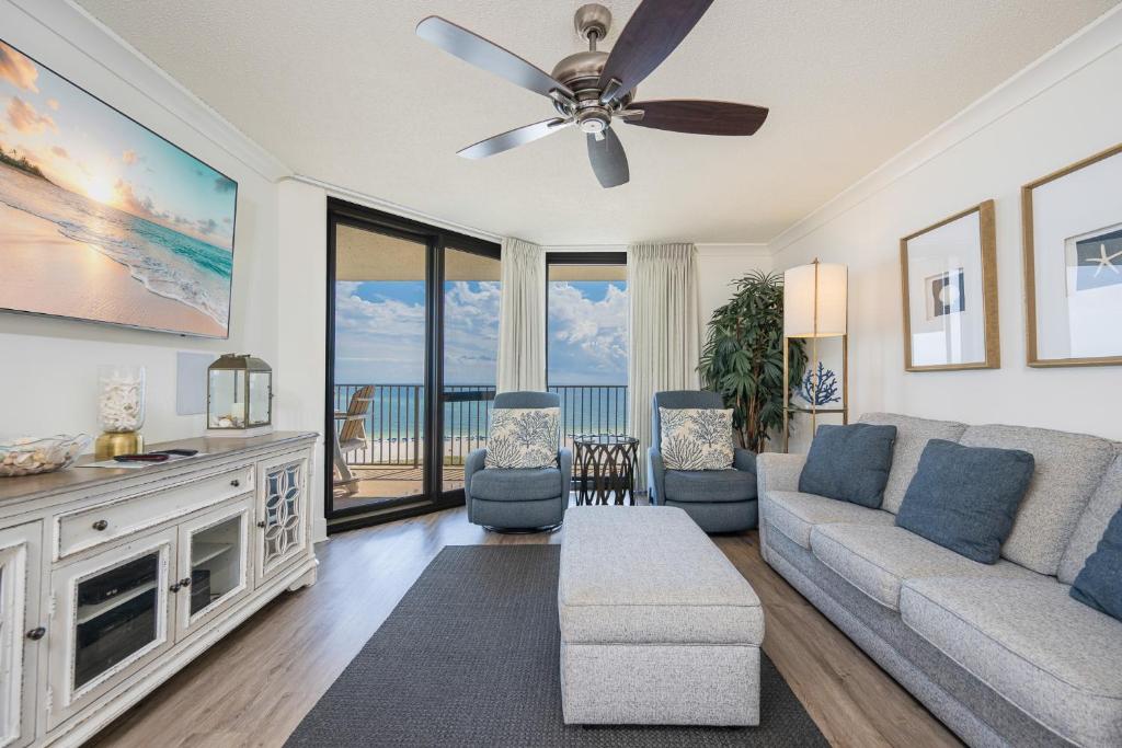a living room with a couch and a ceiling fan at Phoenix VI 6906 in Orange Beach