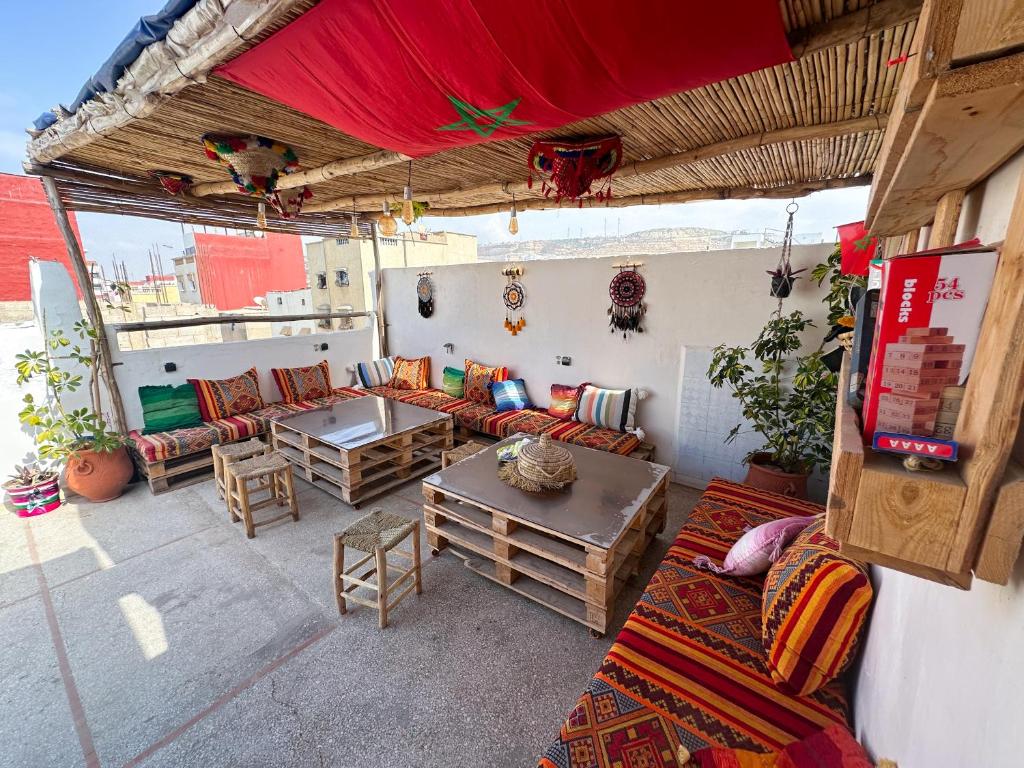 an outdoor living room with couches and a table at Jurassic Surf House Anza in Agadir