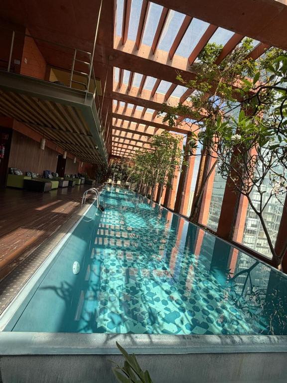 a large indoor swimming pool with blue water at The Reforma 27 Grand in Mexico City