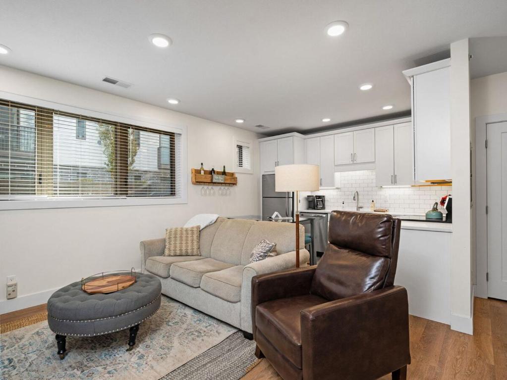 a living room with a couch and a chair at Cozy Capri Condo: Charming 1BR 1BA Downtown! in Traverse City