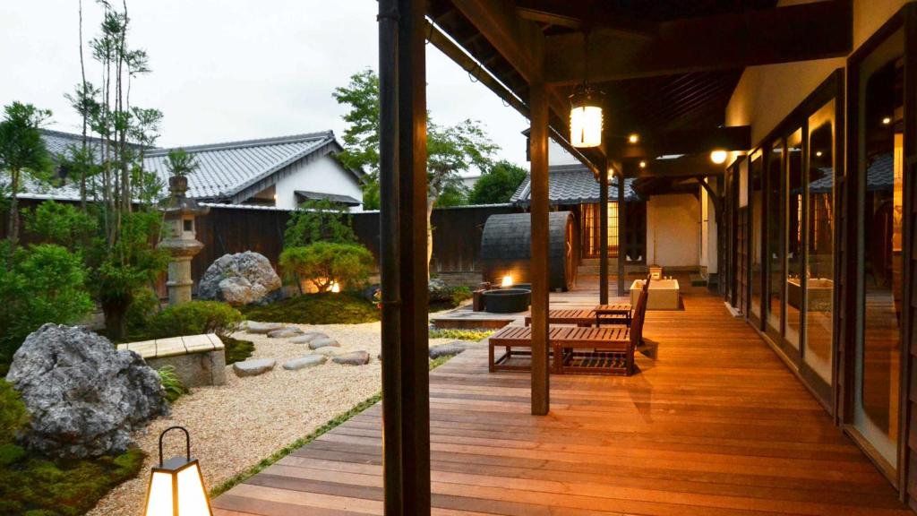 an external view of a house with a wooden deck at 別邸 六花 in Hino