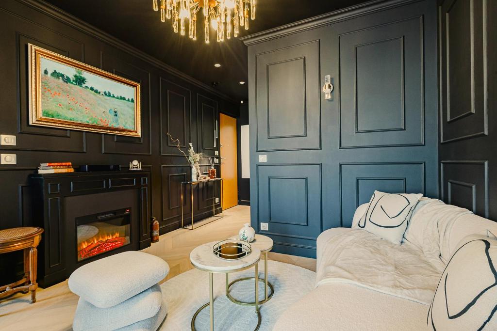 a living room with a couch and a fireplace at Maison Saint Lazare in Vernon