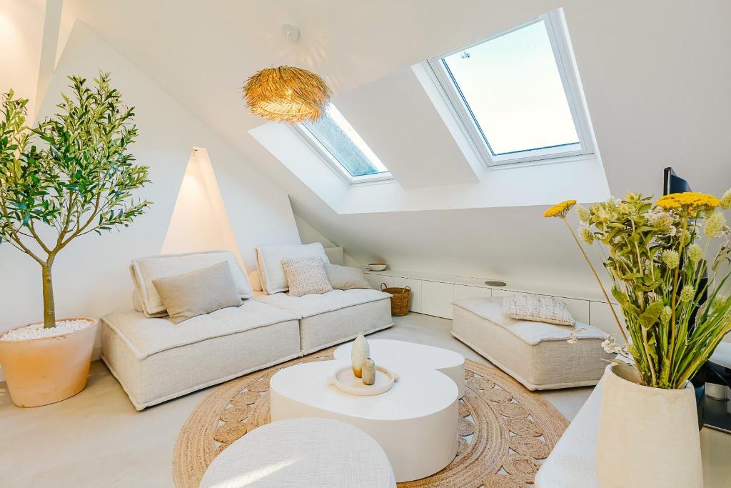 a living room with a couch and a table at Maison Soleil Levant in Vernon