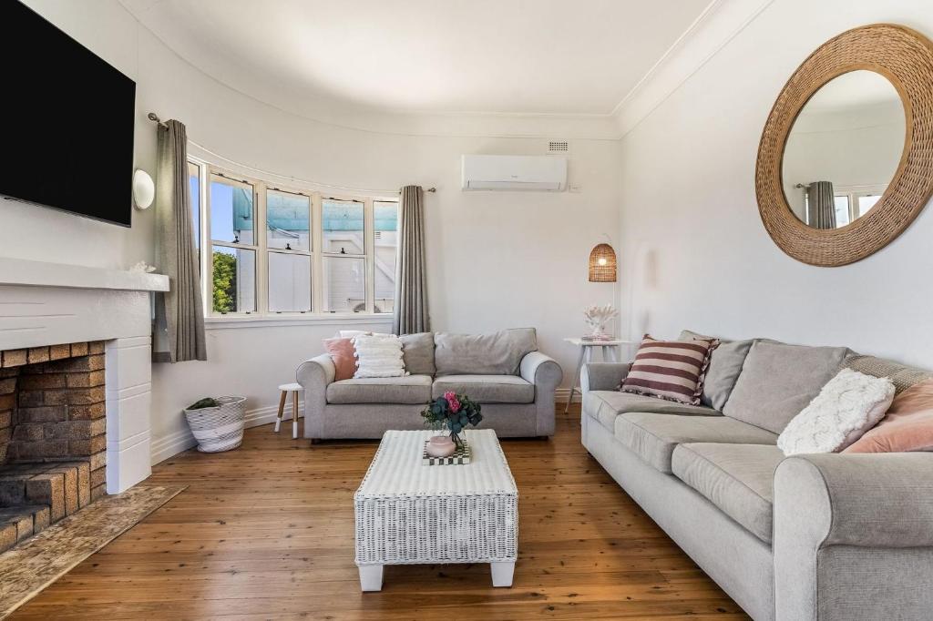 a living room with a couch and a fireplace at Selah - 36 Woodburn Street in Evans Head