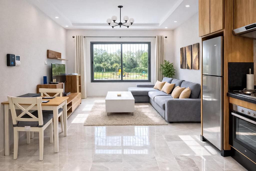 a living room with a couch and a table at Affordable Luxury Apartment in Nouaseur
