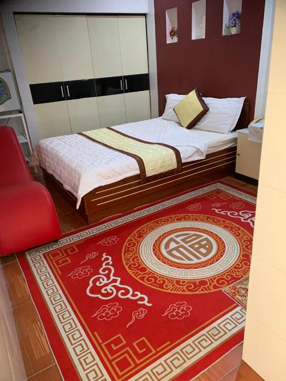 a bedroom with two beds and a red rug at Hotel Tài Phát in Can Tho