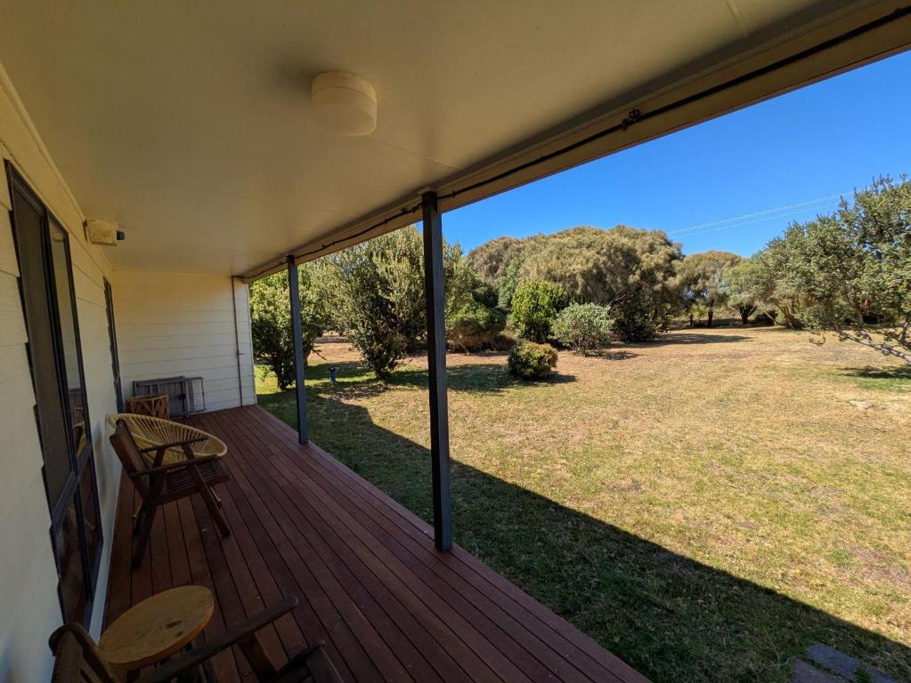 a screened porch with a view of a yard at Swallows Nest in Cape Bridgewater