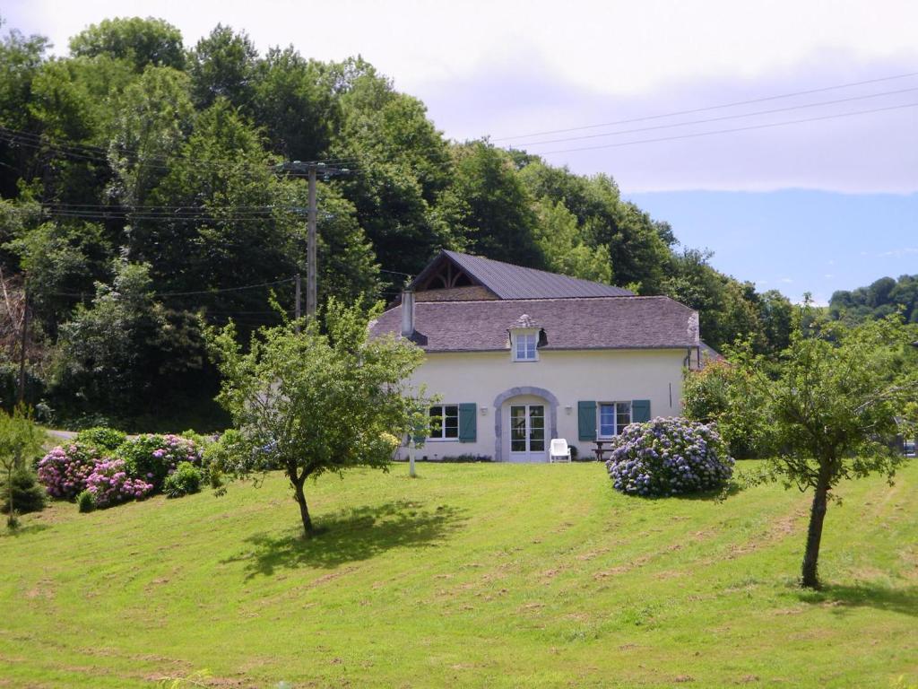 a white house on a hill with trees at Peyre in Aramits