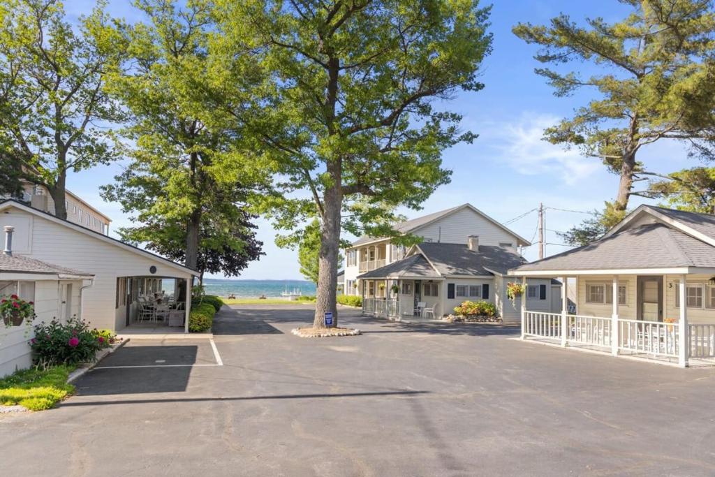 a house with a driveway with trees and houses at Topico Cabin 5 . Topico Cabin 5 in Traverse City