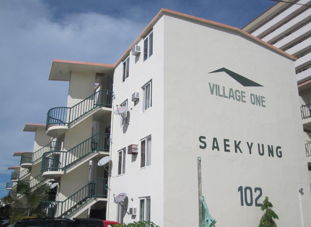 a building with the village one saikiuing sign on it at PG Vacation Rental in Lapu Lapu City