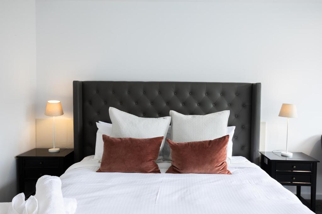 a bedroom with a large white bed with pillows at Bay View Sunrise in Lorne