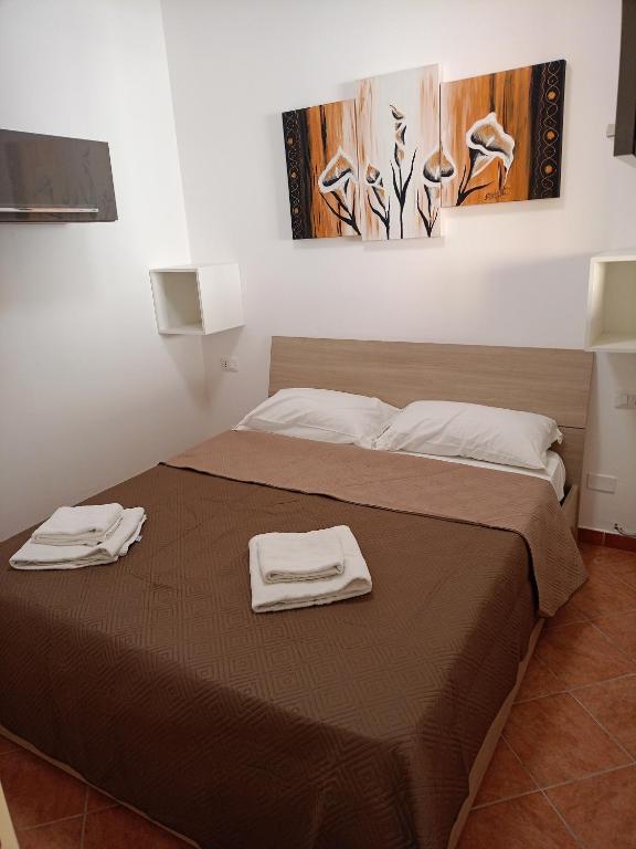 a bedroom with a bed with two towels on it at Fabian Appartament in Bagheria