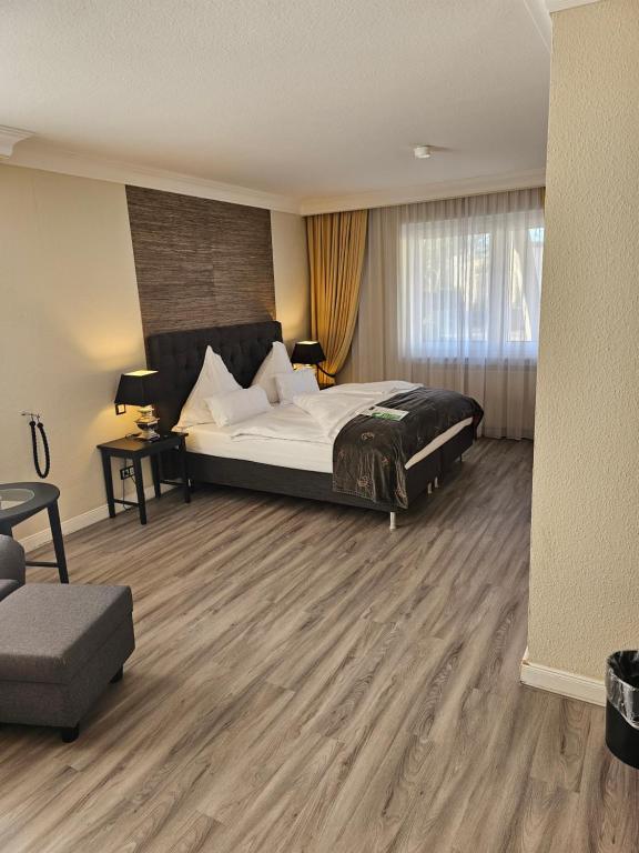 a bedroom with a bed and a chair and a couch at Business & More Boutique Hotel Hamburg in Hamburg