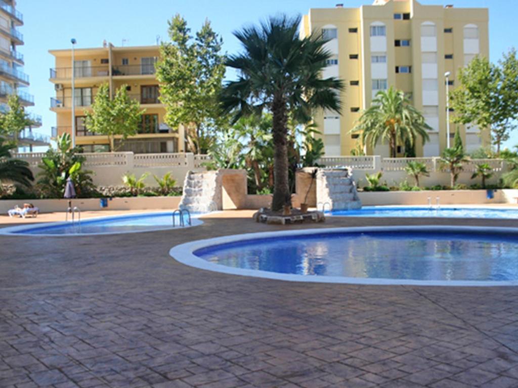 a swimming pool in front of a building at Turquesa Beach Unitursa in Calpe