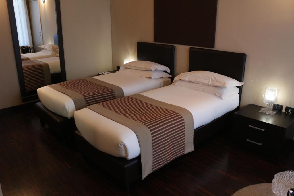 Postel nebo postele na pokoji v ubytování OneMhotel