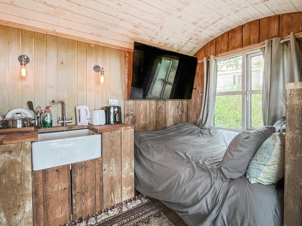 a bedroom with a bed in a tiny house at Coastal Views in Cloughton