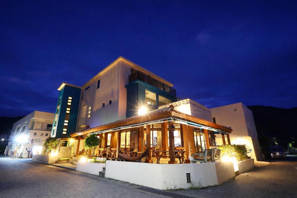 a building with a restaurant in front of it at night at Pension NiraiKanai in Awaren