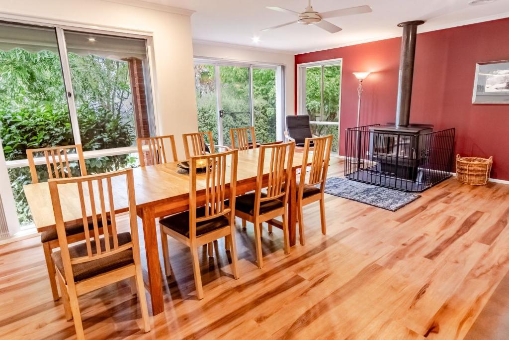 a dining room with a table and chairs and a fireplace at Hargreaves House in Bright