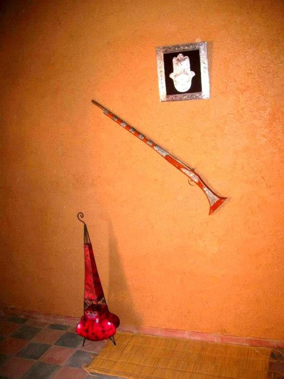 a kite hanging on a wall next to a clock at Tarmguist in Tighmert