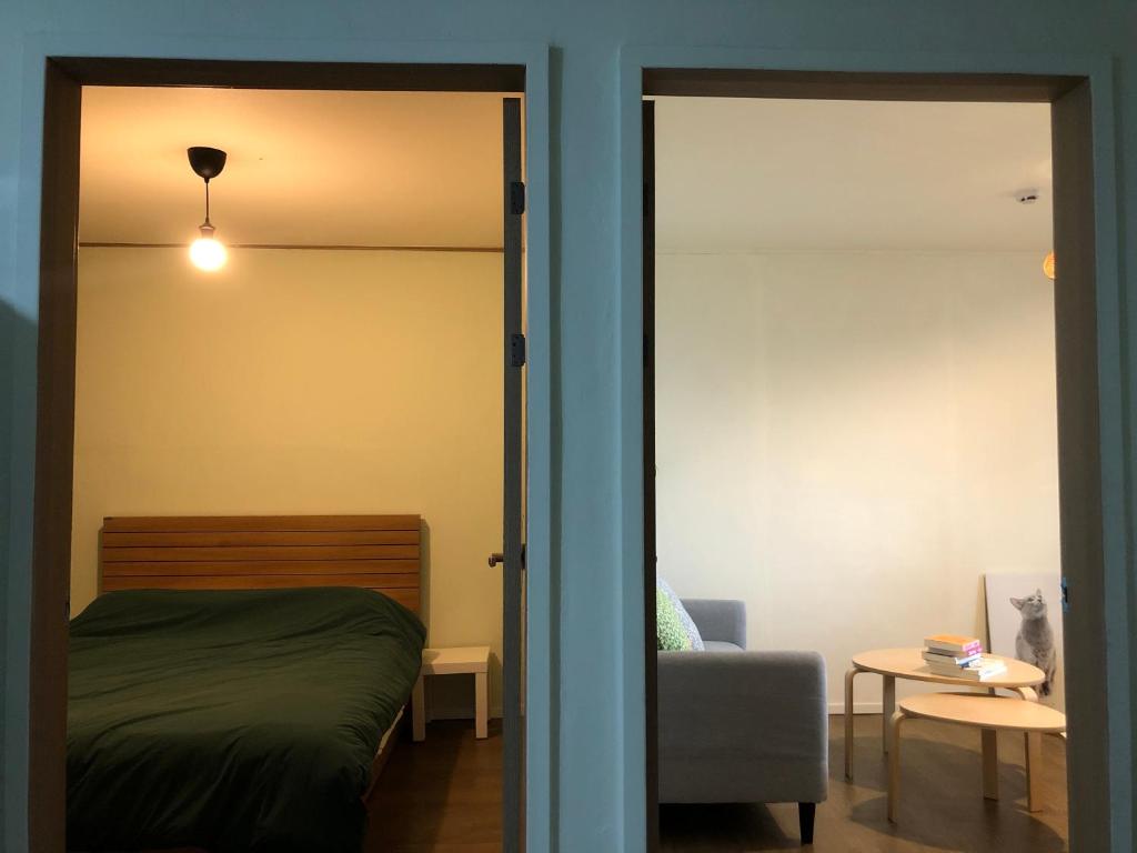a bedroom with a bed and a sliding glass door at 산초리니 Sanchorini in Busan