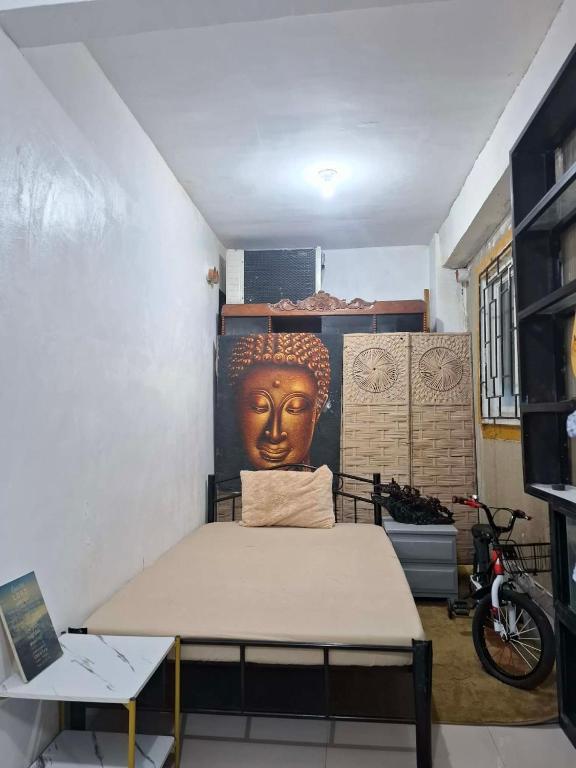 a room with a bed with a head on the wall at Lancaster new city in General Trias