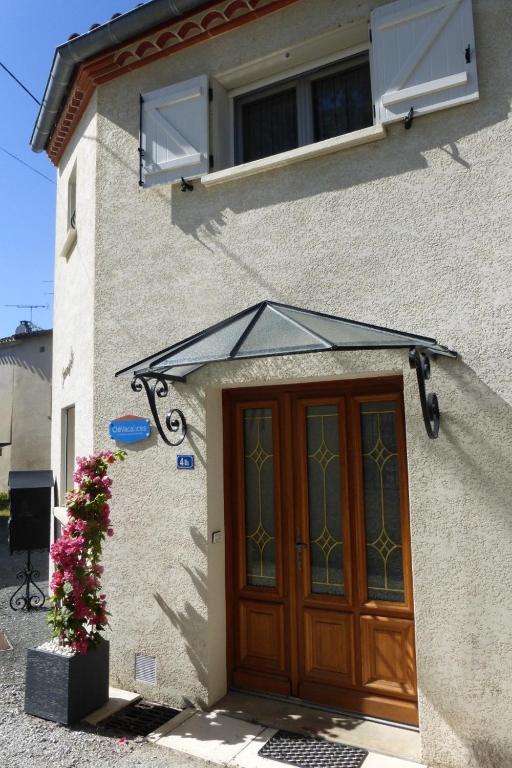 a house with a wooden door and a window at Gîte paumajoly in Castres