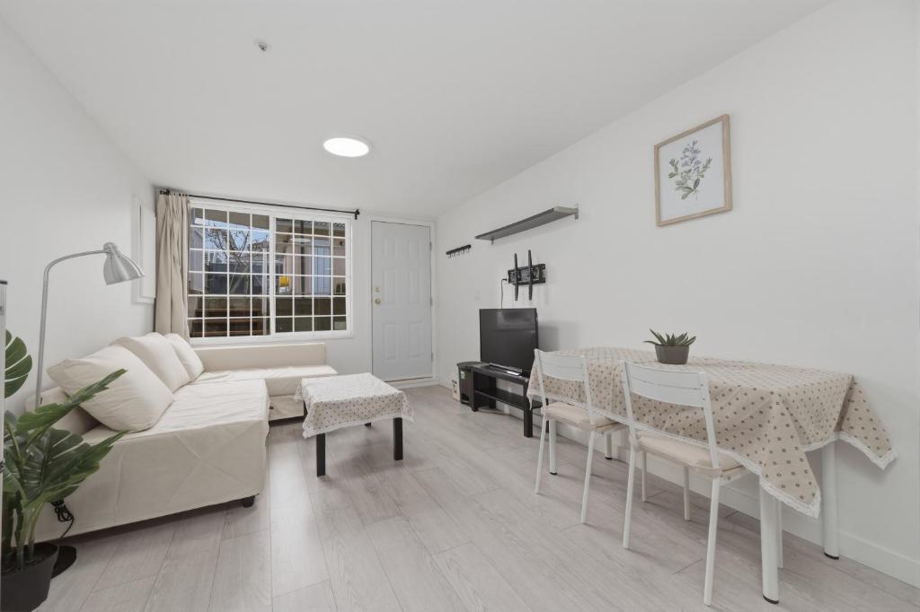 a living room with a couch and a table at Central Van 1bedroom Suite in Vancouver