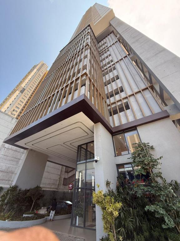 a building in front of a tall building at Tri-Zen Luxury Apartment Colombo, Tower 02, 20F, A2 in Colombo