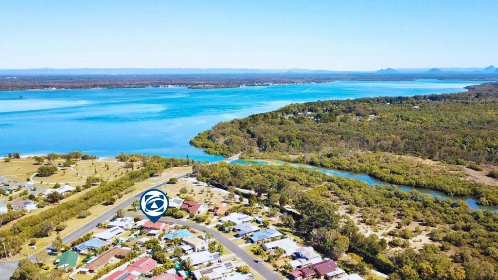 an aerial view of a city and a river at Flamingo Sunset Retreat in Banksia Beach