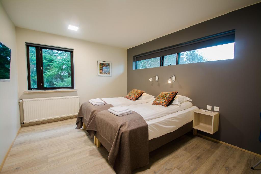 1 dormitorio con cama y ventana grande en Brekkugerdi Guesthouse en Laugaras