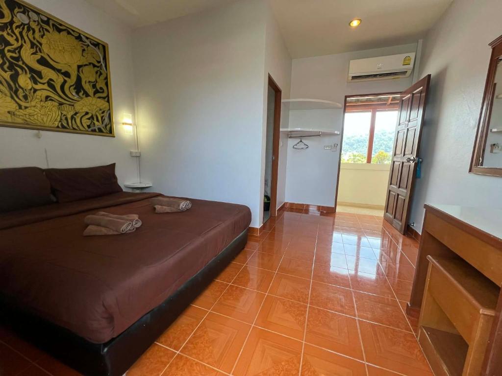 a bedroom with a bed in a room at Ban Elephant Blanc Apartment in Kata Beach
