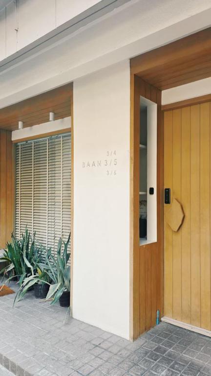 a front door of a building with plants at Baan Rak BTS phromphong Emsphere in Bangkok