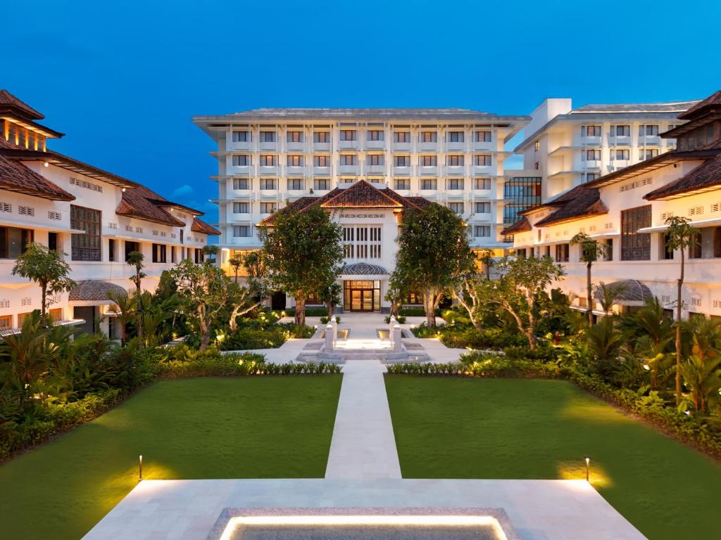 a courtyard with a large building in the background at Grand Hotel De Djokja in Yogyakarta