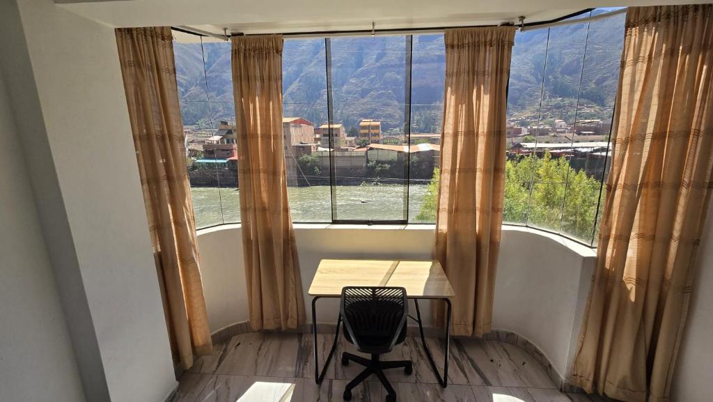 a table in a room with a large window at Amazing views PISAQ in Pisac