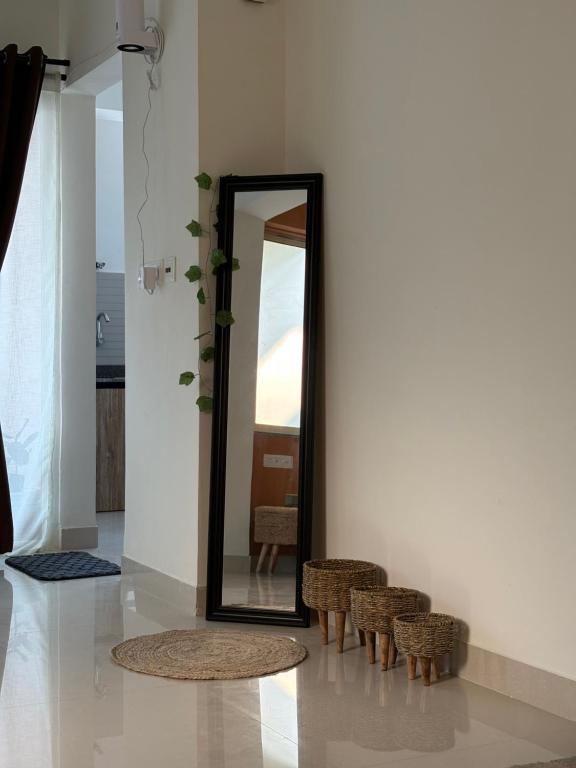 a mirror in a room with two chairs and a table at Live Easy in Mātigara