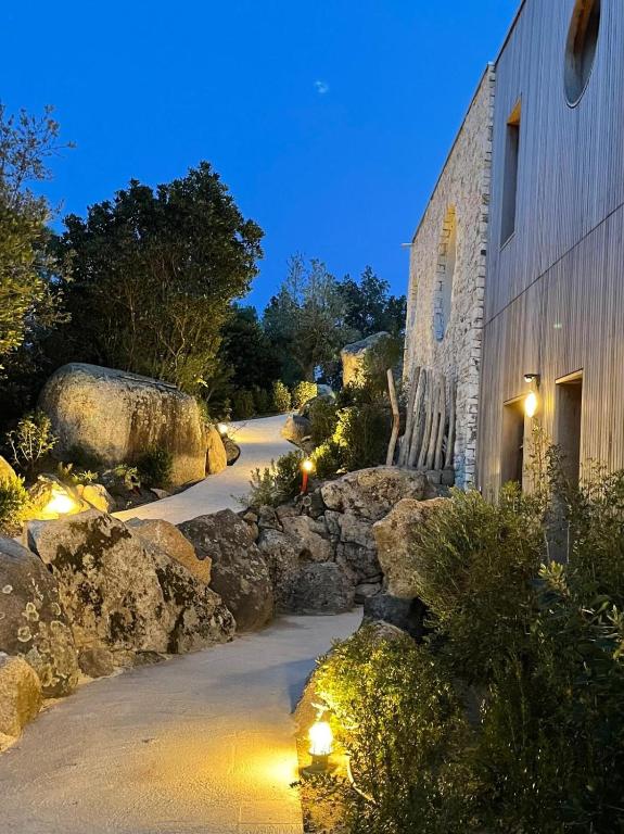 a stone building with lights on the side of a road at luxe et sérénité in Lecci