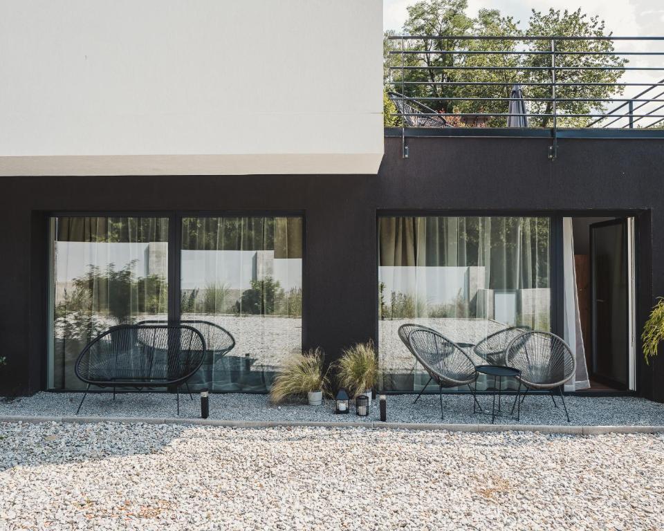 two chairs and a table in front of a house at Villa Gall in Český Krumlov