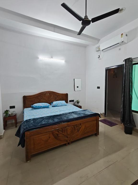 a bedroom with a bed and a ceiling fan at Shivprasad homestay in Varanasi