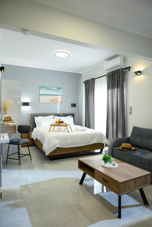 a bedroom with a bed and a couch and a table at Coastline 1 in Perea