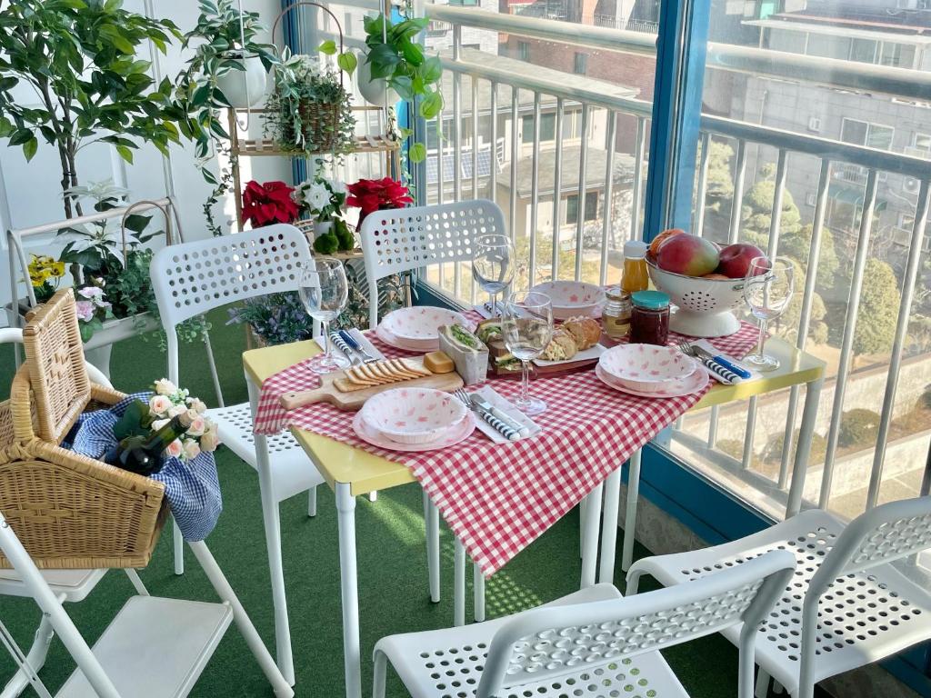 a table with plates of food on a balcony at Mapo Panorama Stay in Seoul