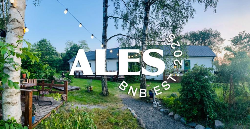 a large sign that reads aes bends in a yard at Ales BnB in Löderup