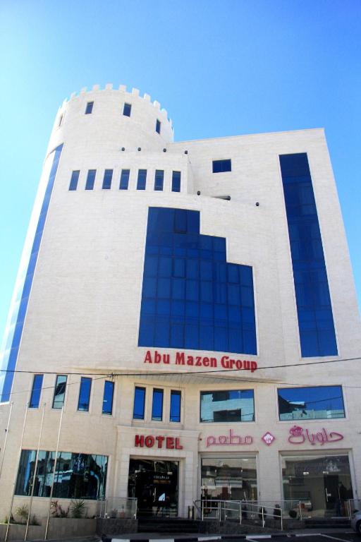 a large building with a moroccan group sign on it at Abu Mazen Hotel in Khirbat an Naşārá
