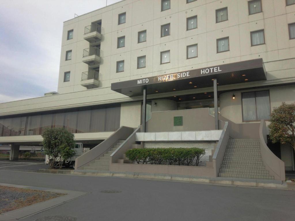 a hotel building with a staircase in front of it at Mito Riverside Hotel in Mito