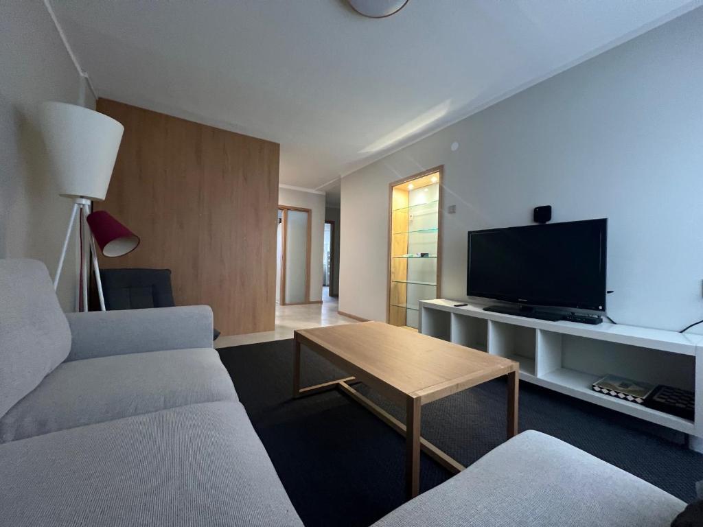 a living room with a couch and a flat screen tv at Emmaste Apartment in Emmaste