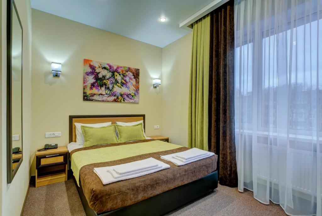 Кровать или кровати в номере Отель Комфорт Класс