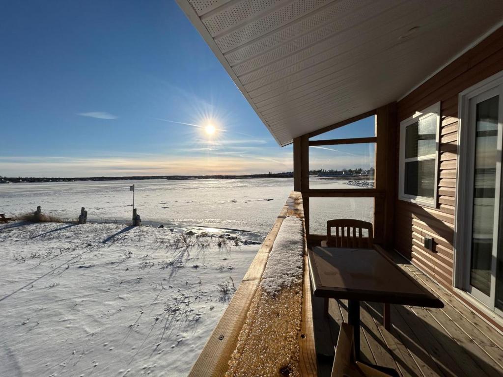 a porch of a house with snow on the ground at Cocagne Ocean Suites- Bed & Breakfast in Cocagne 
