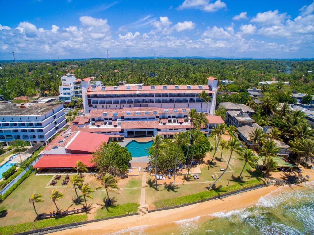 an aerial view of a building on the beach at Citrus Hikkaduwa in Hikkaduwa