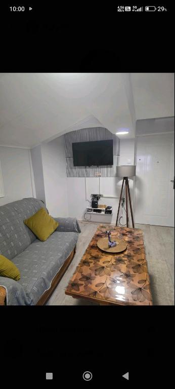 a living room with a couch and a table at Apartment Đina in Plužine