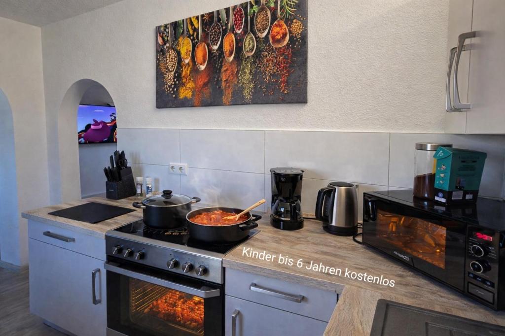 a kitchen with two pots of food on a stove at Ferienwohnung NR3 in Großräschen